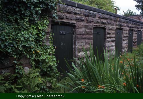 Stone-faced entrance to tunnels built into earth bank.  Possibly built to function as storage cellars. - Copyright (c) Alec Scaresbrook
